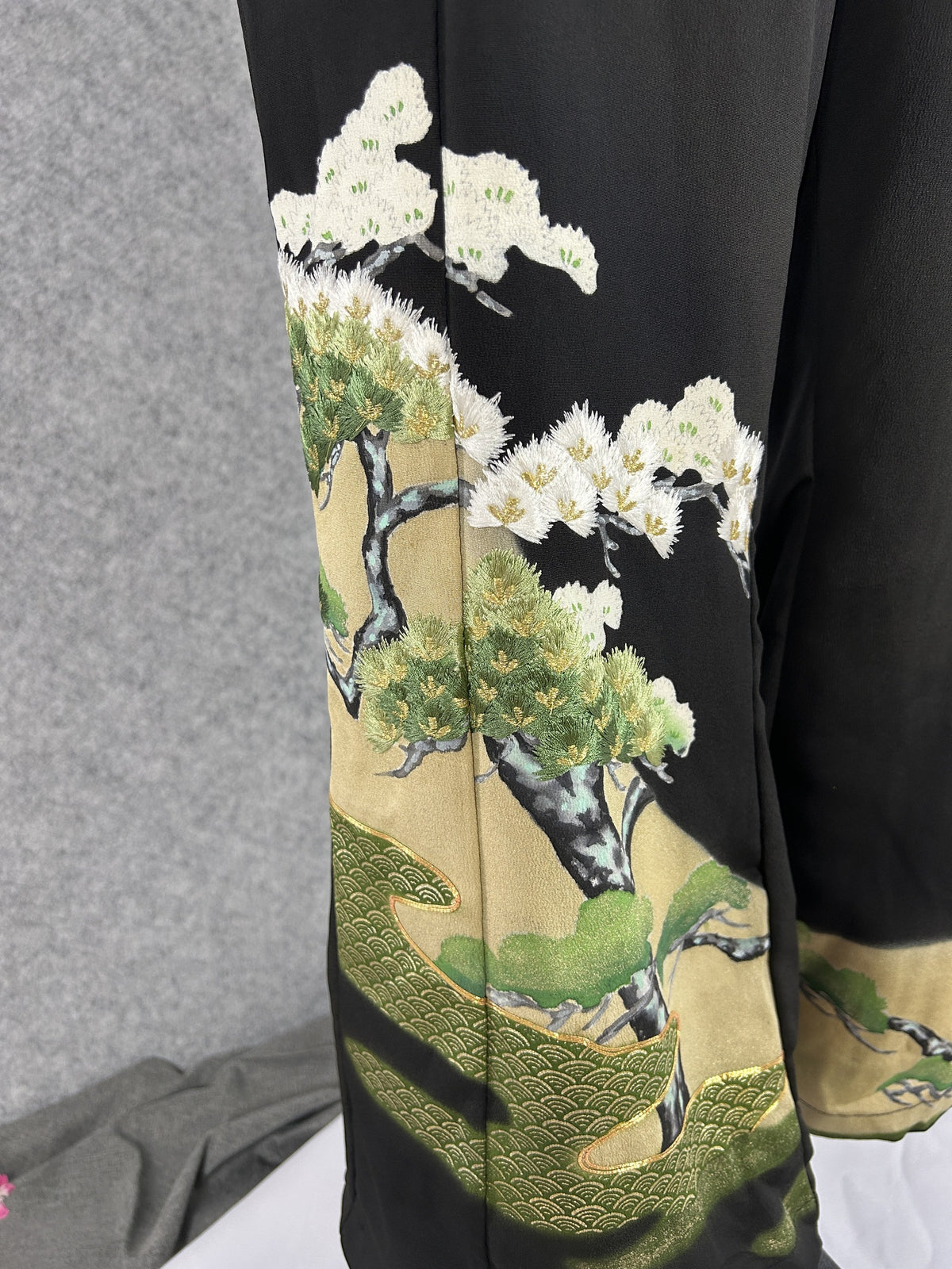 Black upcycled tomesode kimono wide leg pants with a pine tree on gold, detail of the pine tree on the left leg
