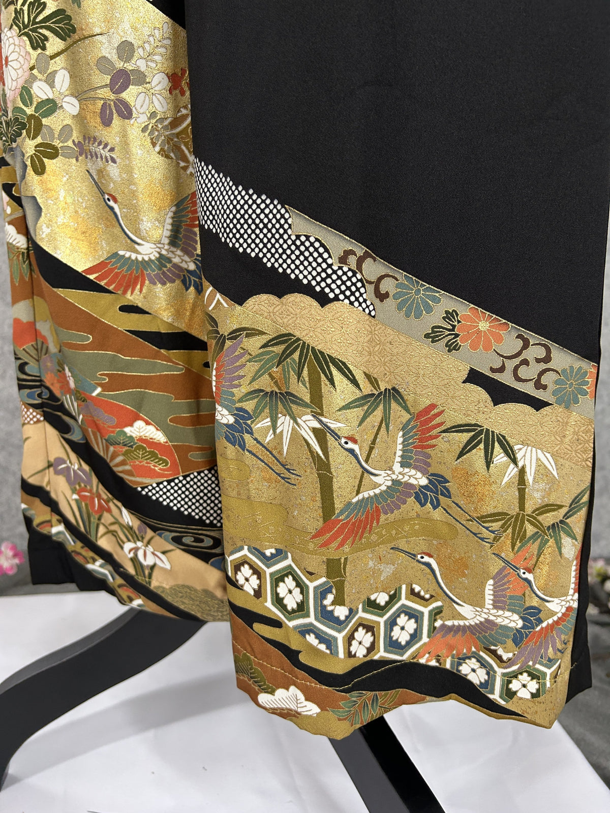 Black upcycled tomesode kimono wide leg pants with gold bands, cranes and chrysanthemums, detail of the cranes and bamboo at the hem