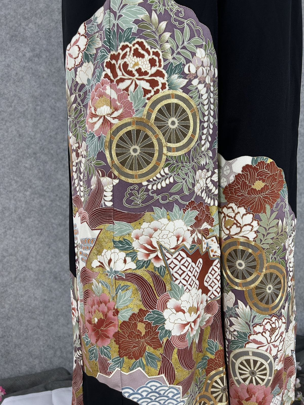 Black upcycled tomesode kimono wide leg pants with gold wheels and peonies on mauve, detail of the hem panel on the left leg