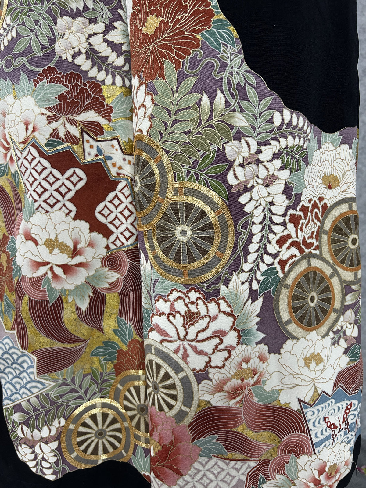 Black upcycled tomesode kimono wide leg pants with gold wheels and peonies on mauve, close-up of the painted wheels and peonies
