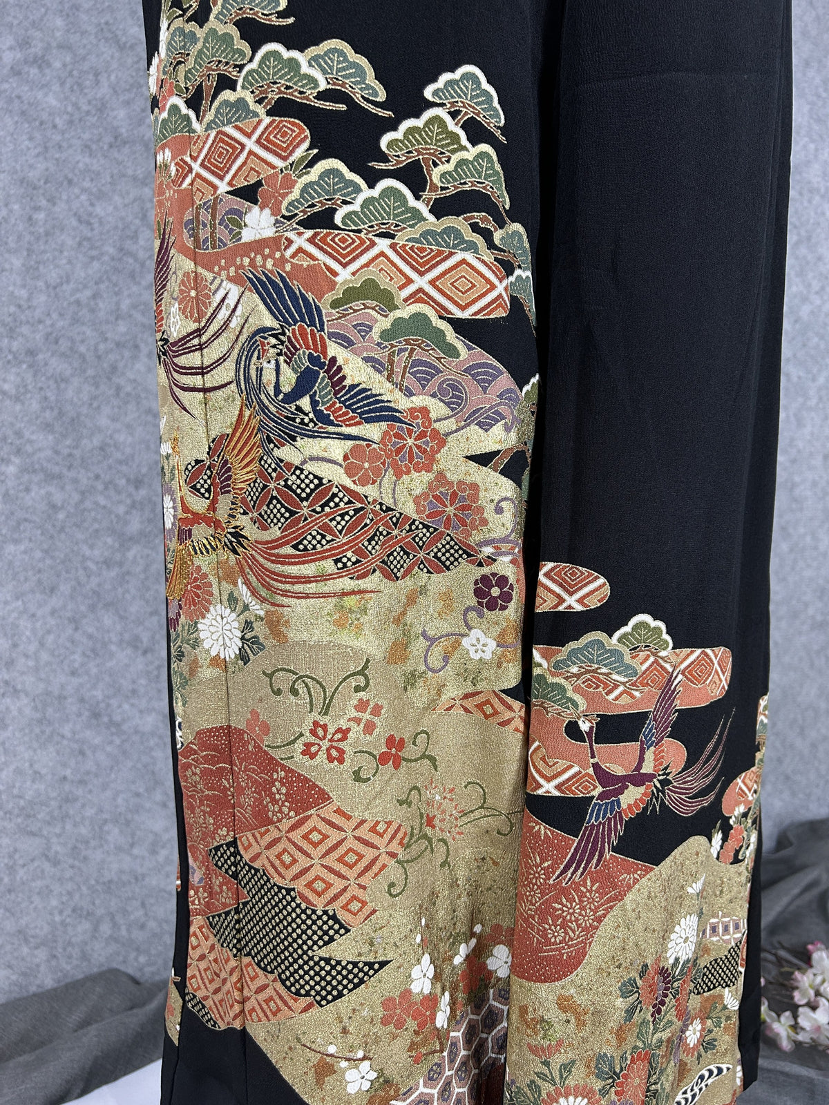 Black upcycled tomesode kimono wide leg pants with birds, gold clouds and pine, detail of the painted birds and pine on the left leg