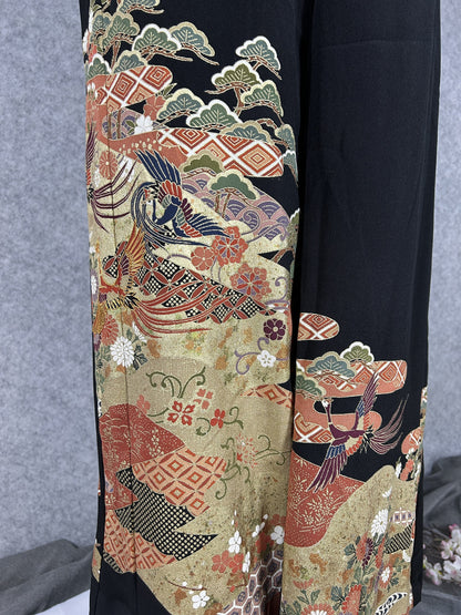 Black upcycled tomesode kimono wide leg pants with birds, gold clouds and pine, detail of the painted birds and pine on the left leg