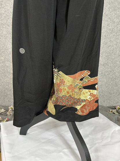 Black upcycled tomesode kimono wide leg pants with birds, gold clouds and pine, back view with family crest