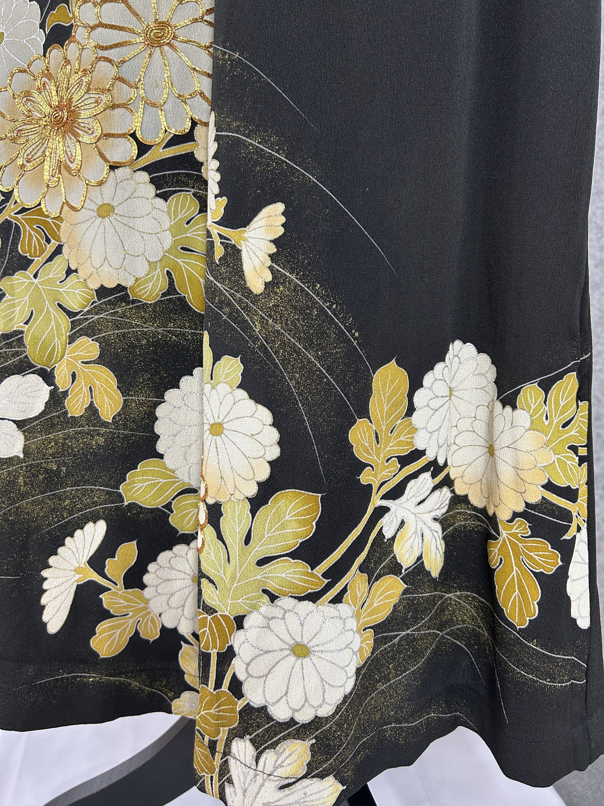 Black upcycled tomesode kimono wide leg pants with white and gold chrysanthemums, close-up of the gold and white chrysanthemums