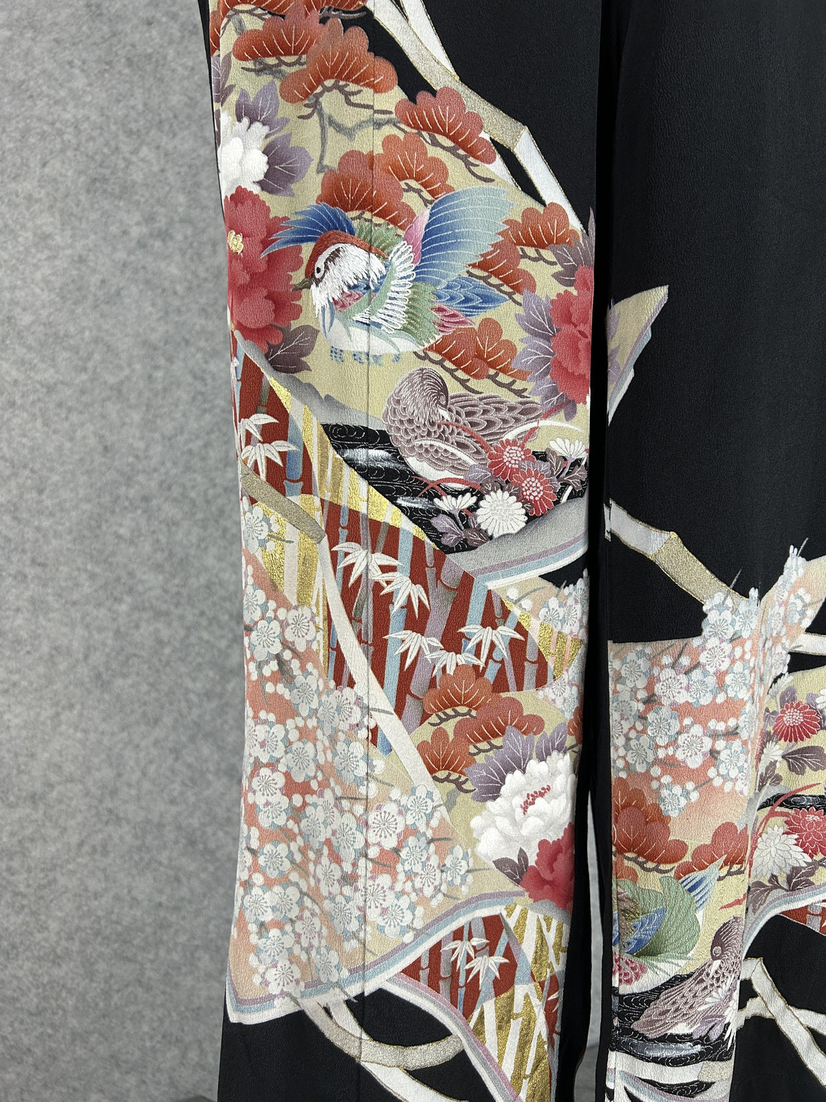 Black upcycled tomesode kimono wide leg pants with mandarin ducks and peonies in fan panels, detail of the fan panels with ducks on the left leg