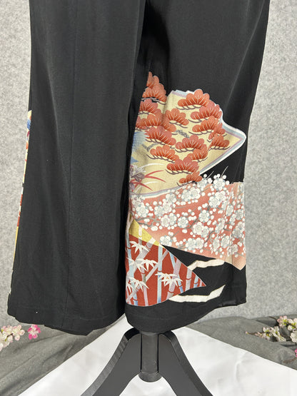 Black upcycled tomesode kimono wide leg pants with mandarin ducks and peonies in fan panels, back view
