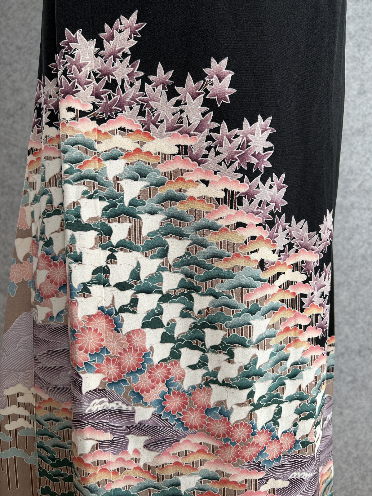 Black kimono wrap skirt, detail of pine trees, maple leaves and flowers in green and coral