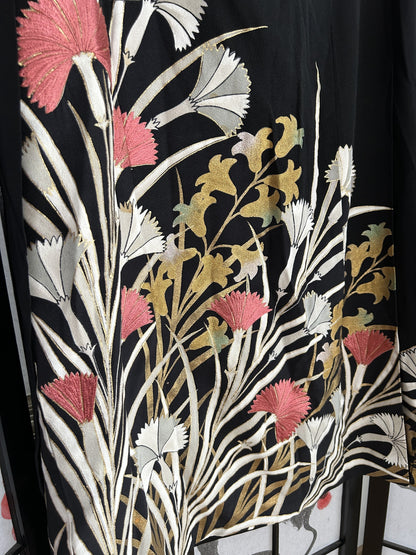 Black kimono wrap skirt, detail of pink and white flowers at hem