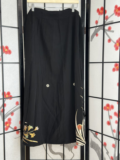 Black kimono wrap skirt, back view with small floral design at hem