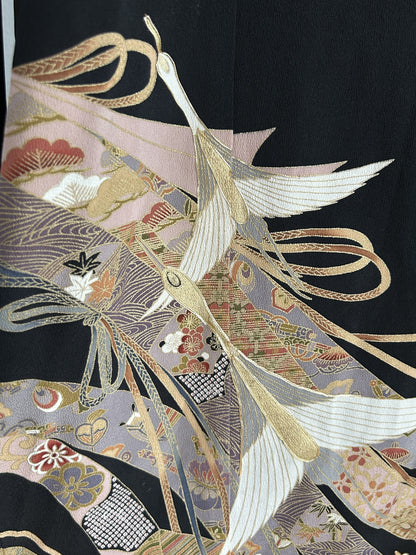 Black kimono wrap skirt, close-up of white cranes over lilac patterned bands