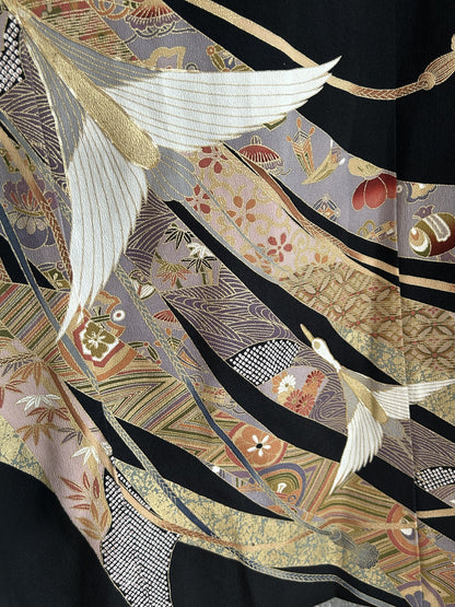 Black kimono wrap skirt, detail of flying cranes and gold patterned ribbons