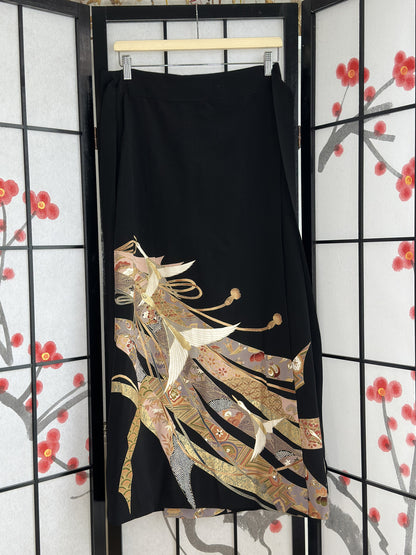 Black kimono wrap skirt with white cranes and gold ribbon design, full view