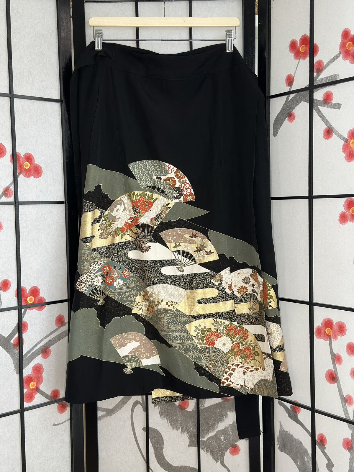 Black kimono wrap skirt with folding fan design in green and cream, full view