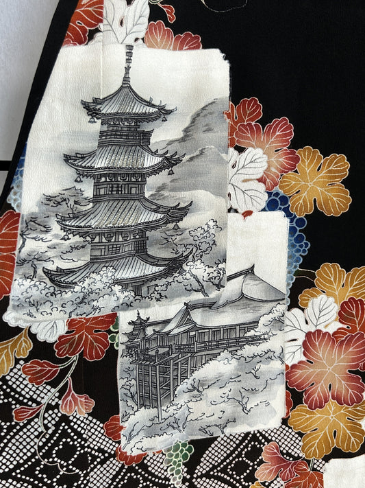 Black kimono wrap skirt, close-up of grey pagoda picture with red leaves