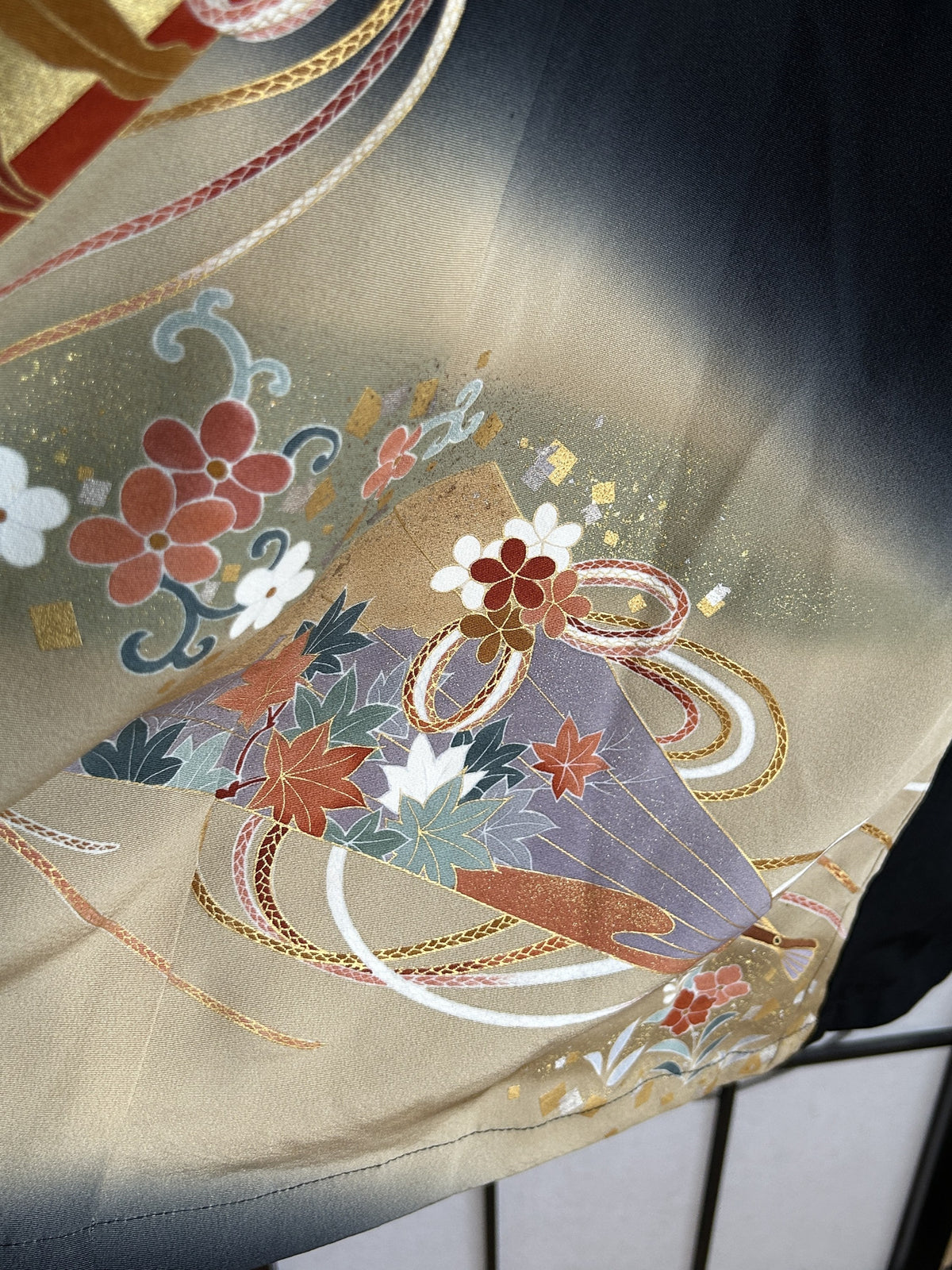 Black kimono wrap skirt, detail of lilac fan with maple leaves on beige