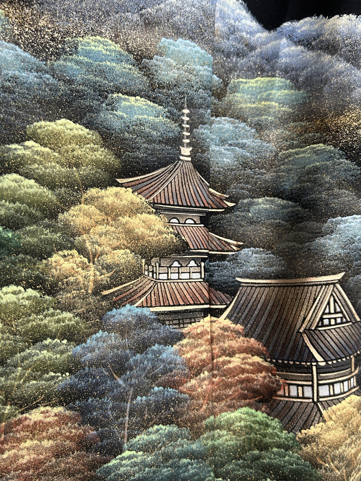 Black kimono wrap skirt, close-up of pagoda among colourful trees