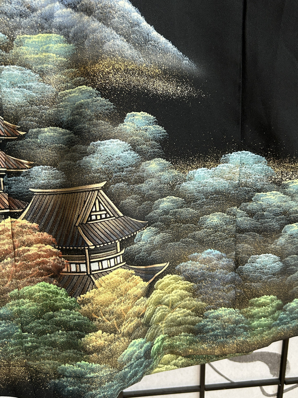 Black kimono wrap skirt, detail of temple roof and trees at hem