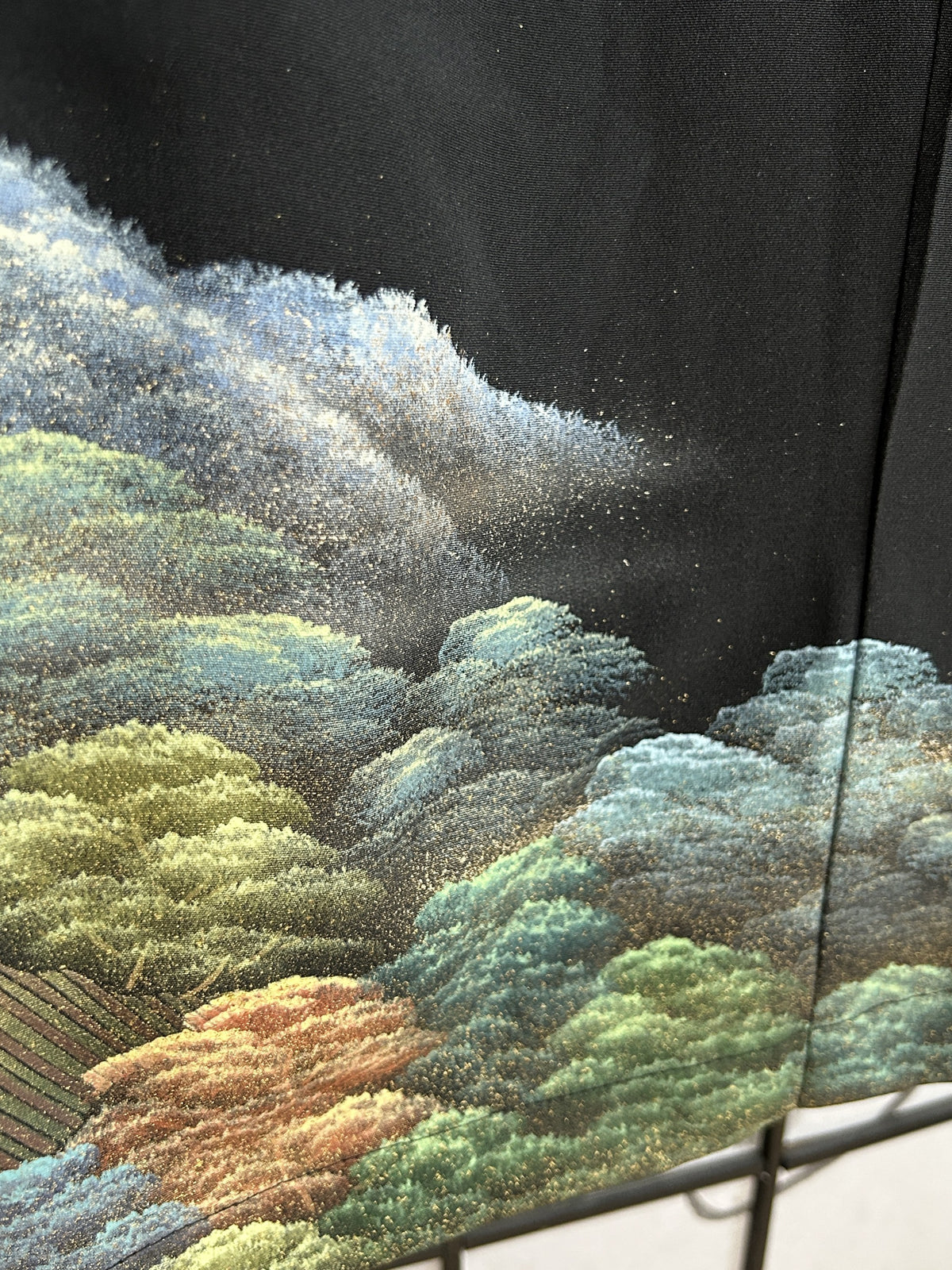 Black kimono wrap skirt, detail of misty hill and green trees