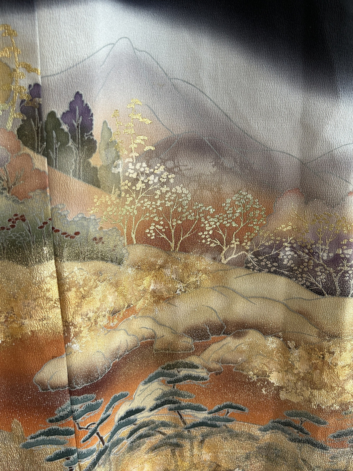 Black kimono wrap skirt, detail of golden trees, hills and pines