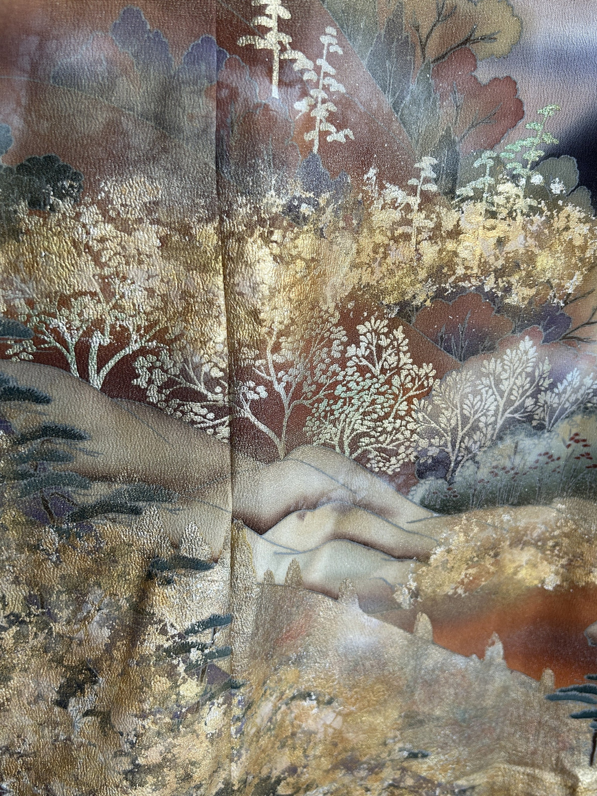 Black kimono wrap skirt, close-up of white and gold trees on hills