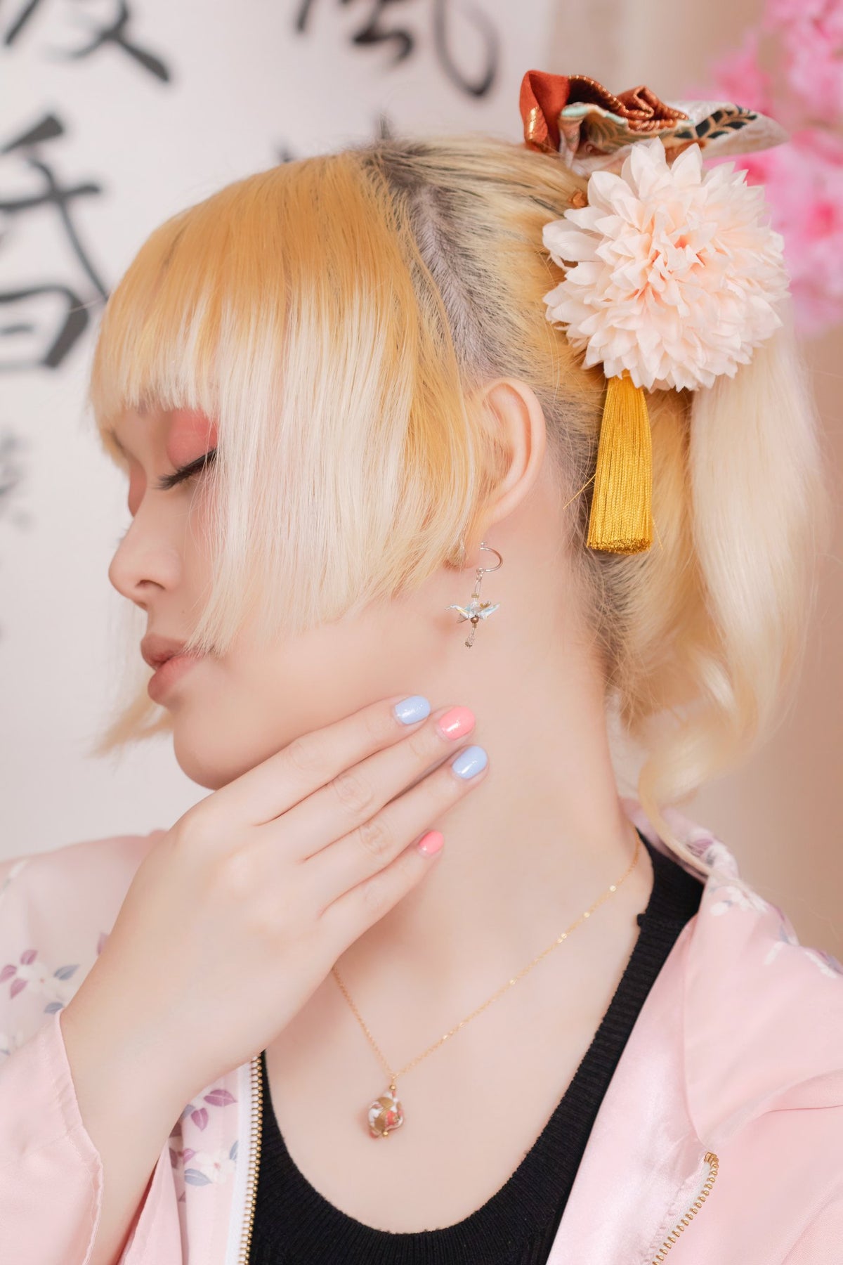 Model wearing Crane & Cabochon Origami Earrings in silver, side profile