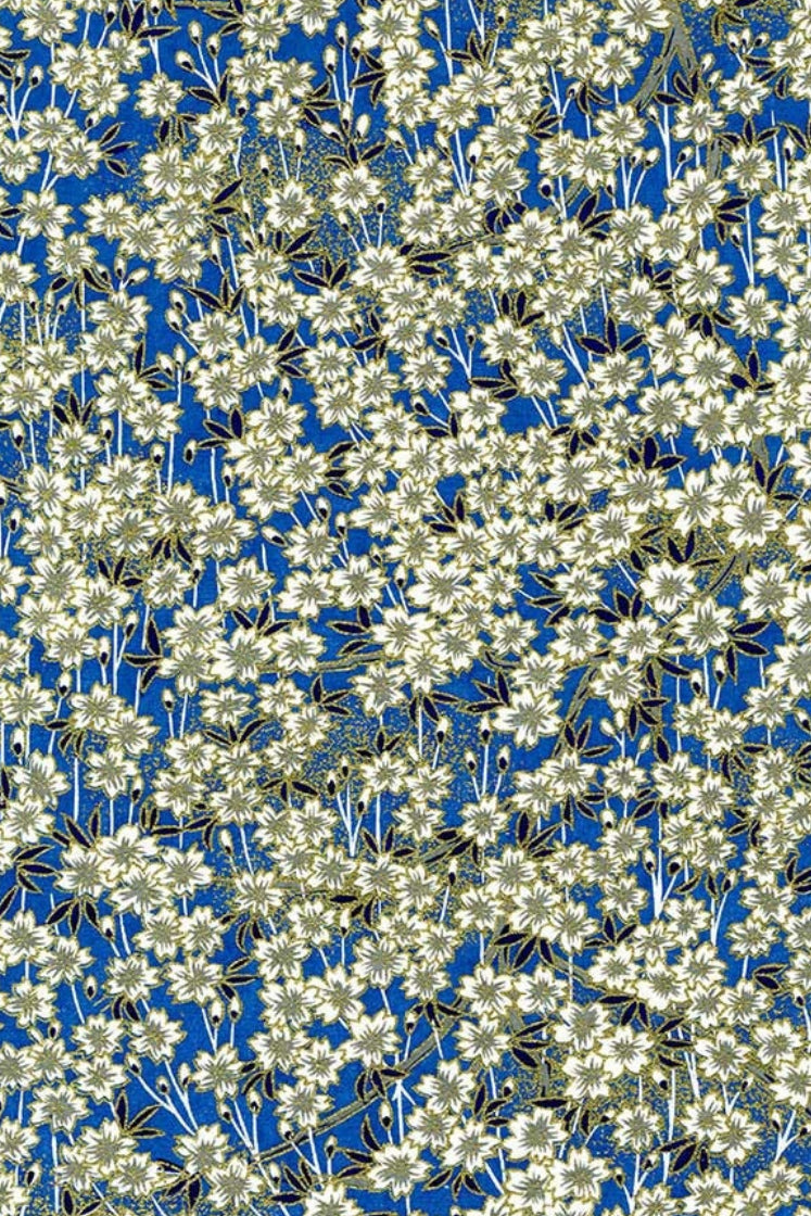Pattern of blue and white flowers on a green background