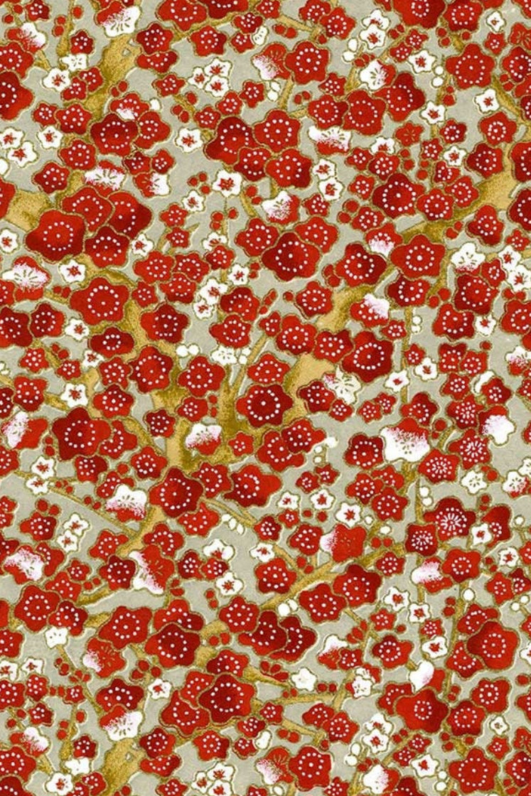 Patterned fabric with red and white floral design on a beige background