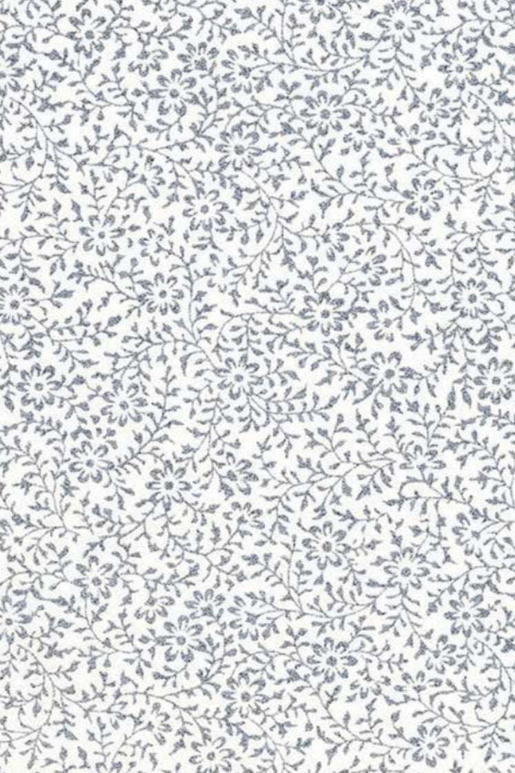 Patterned chiyogami paper with small floral designs on a white background