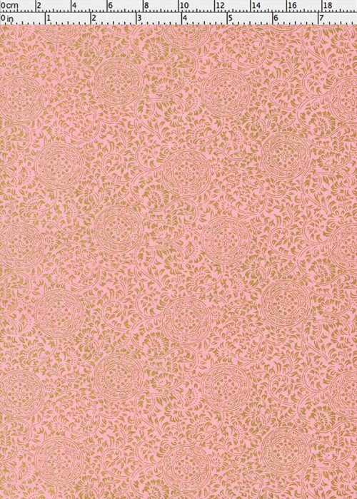 Pink chiyogami paper with a subtle pattern on a pink background with a ruler as scale