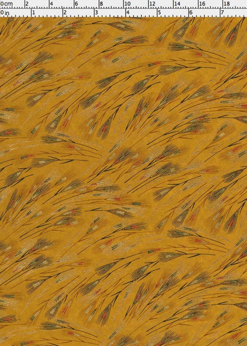 Patterned chiyogami paper with feather designs on a yellow background with a ruler for scale
