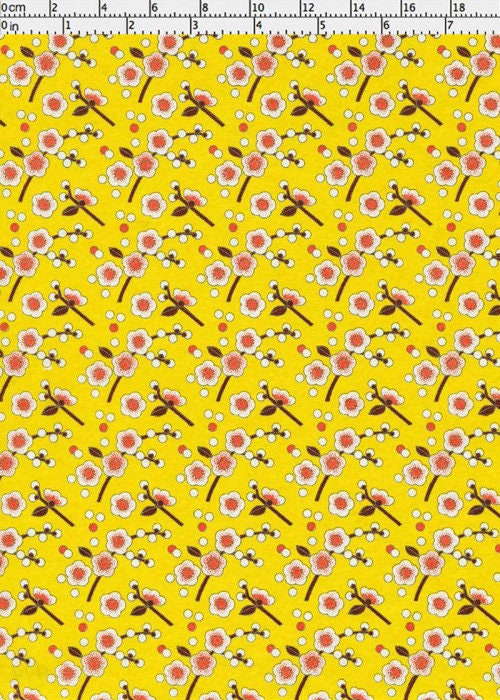 Chiyogami paper with Floral pattern on a yellow background with a ruler for scale