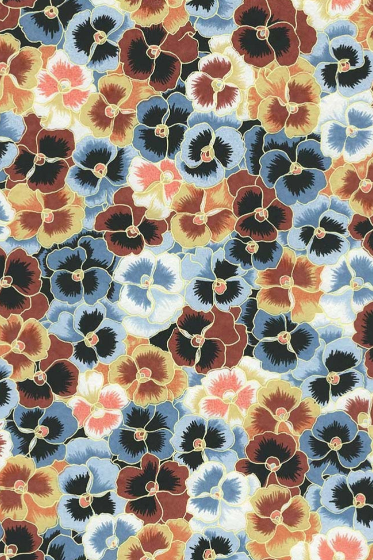 Patterned chiyogami paper with multicolored flowers on a blue background