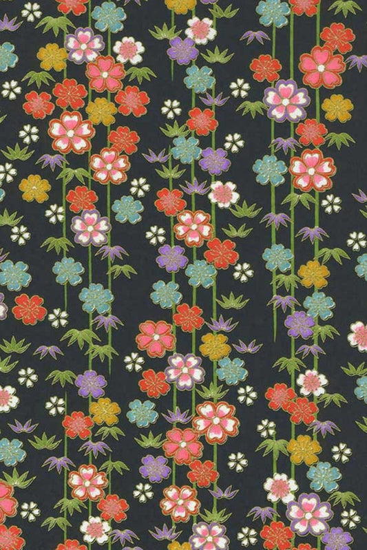 Chiyogami paper patterned with multicolor flowers on a black background.