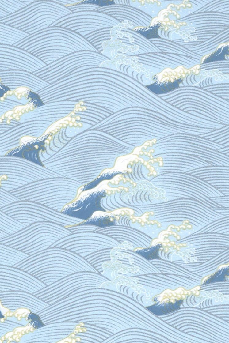Chiyogami paper with wave pattern with white peaks on a blue background