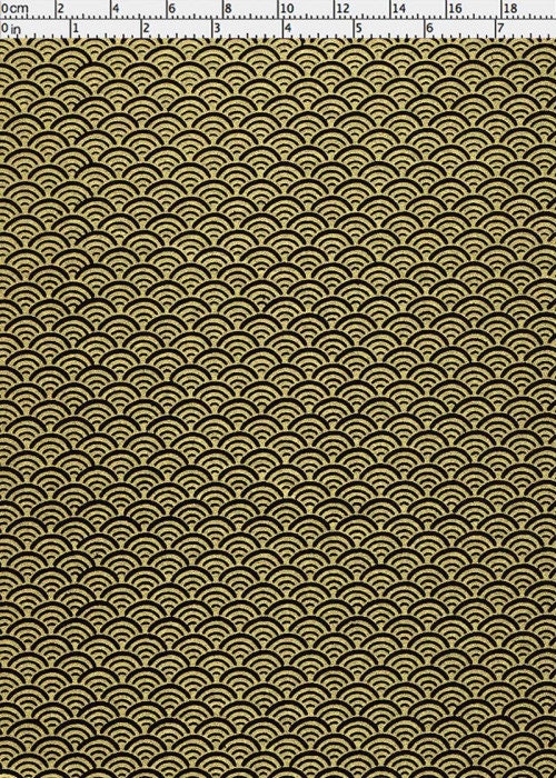 Gold wave pattern on black fabric with a ruler at the top.