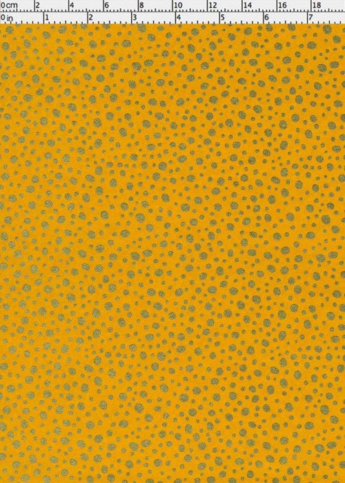 Yellow chiyogami paper with small gray floral pattern with a ruler for scale