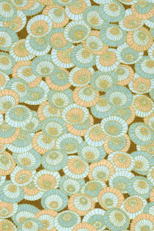 Patterned chiyogami paper with circular floral design in green, orange, and brown.
