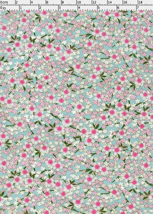 Floral pattern chiyogami paper with pink flowers on a light blue background and a ruler for scale