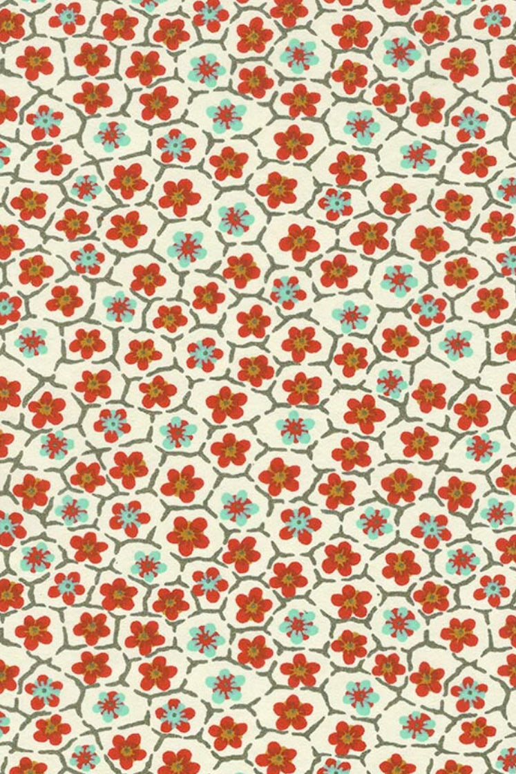 Patterned chiyogami paper with red and blue floral design on a beige background