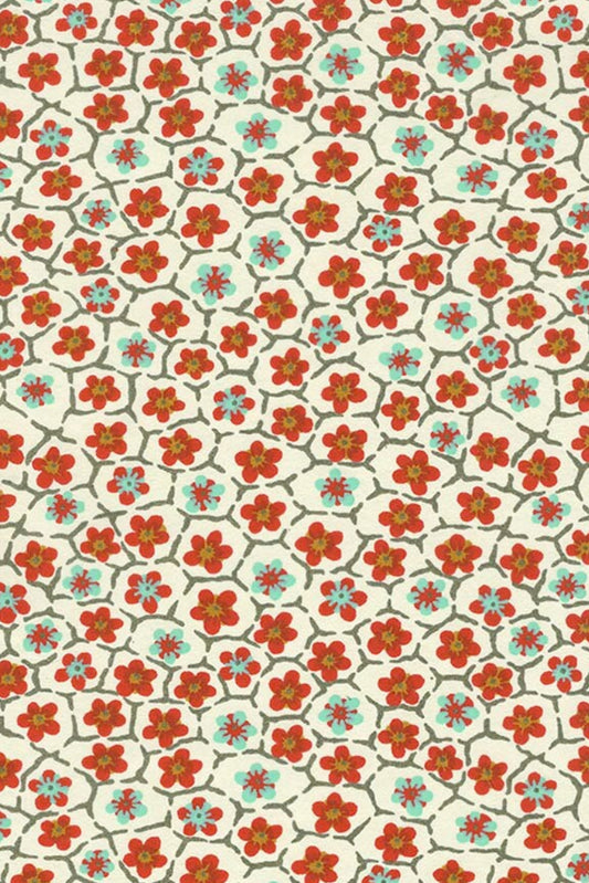 Patterned chiyogami paper with red and blue floral design on a beige background