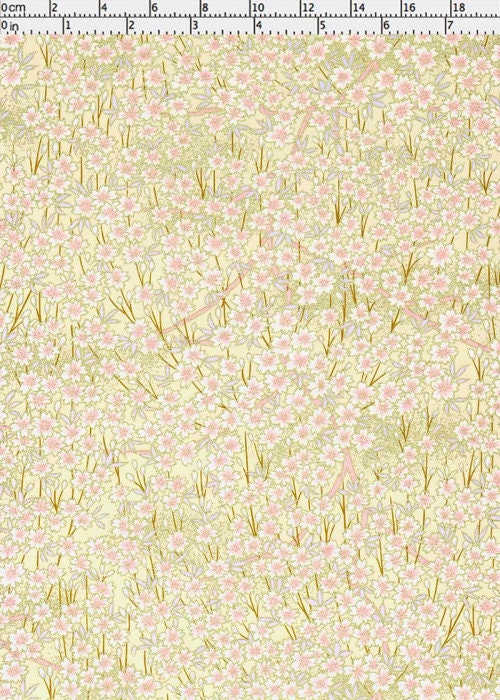 Chiyogami paper with Floral pattern with small pink flowers and green leaves on a light yellow background with a ruler for scale