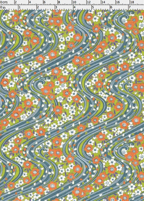 Floral pattern chiyogami paper with wavy lines in orange, green, and white on a gray background with a ruler for scale