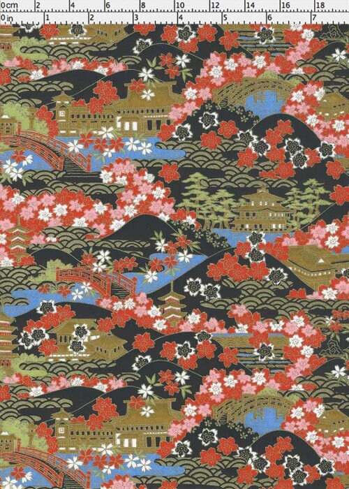 Traditional Japanese landscape chiyogami paper with cherry blossoms and bridges on a black background with a ruler for scale