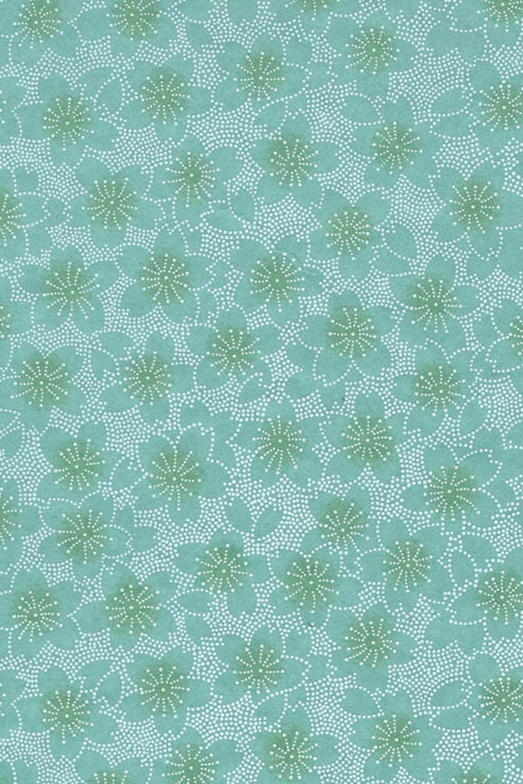 Teal fabric with a subtle pattern of green shapes on a textured background