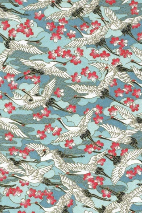 Chiyogami paper with pattern of white birds and red flowers on a blue background