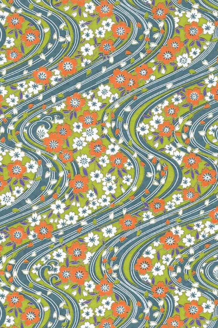 Patterned chiyogami paper with wavy lines and floral design in green, orange, and white.