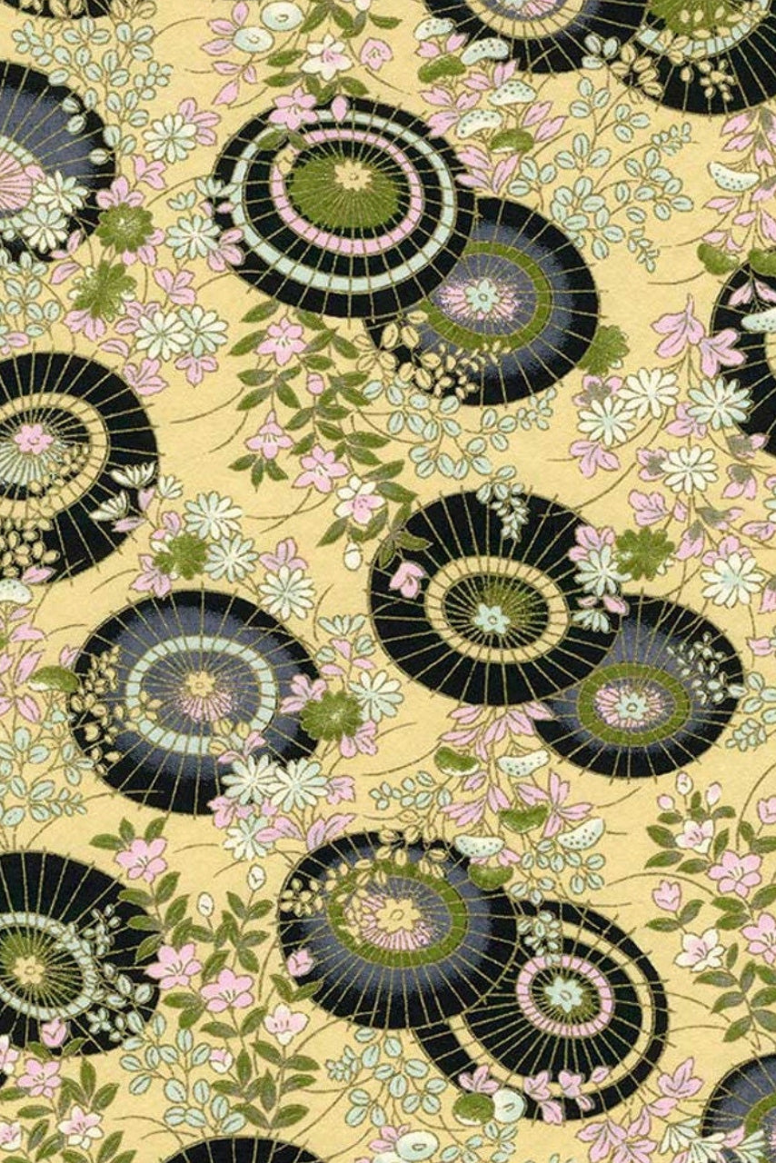 Patterned chiyogami paper with black and green circular designs on a beige background