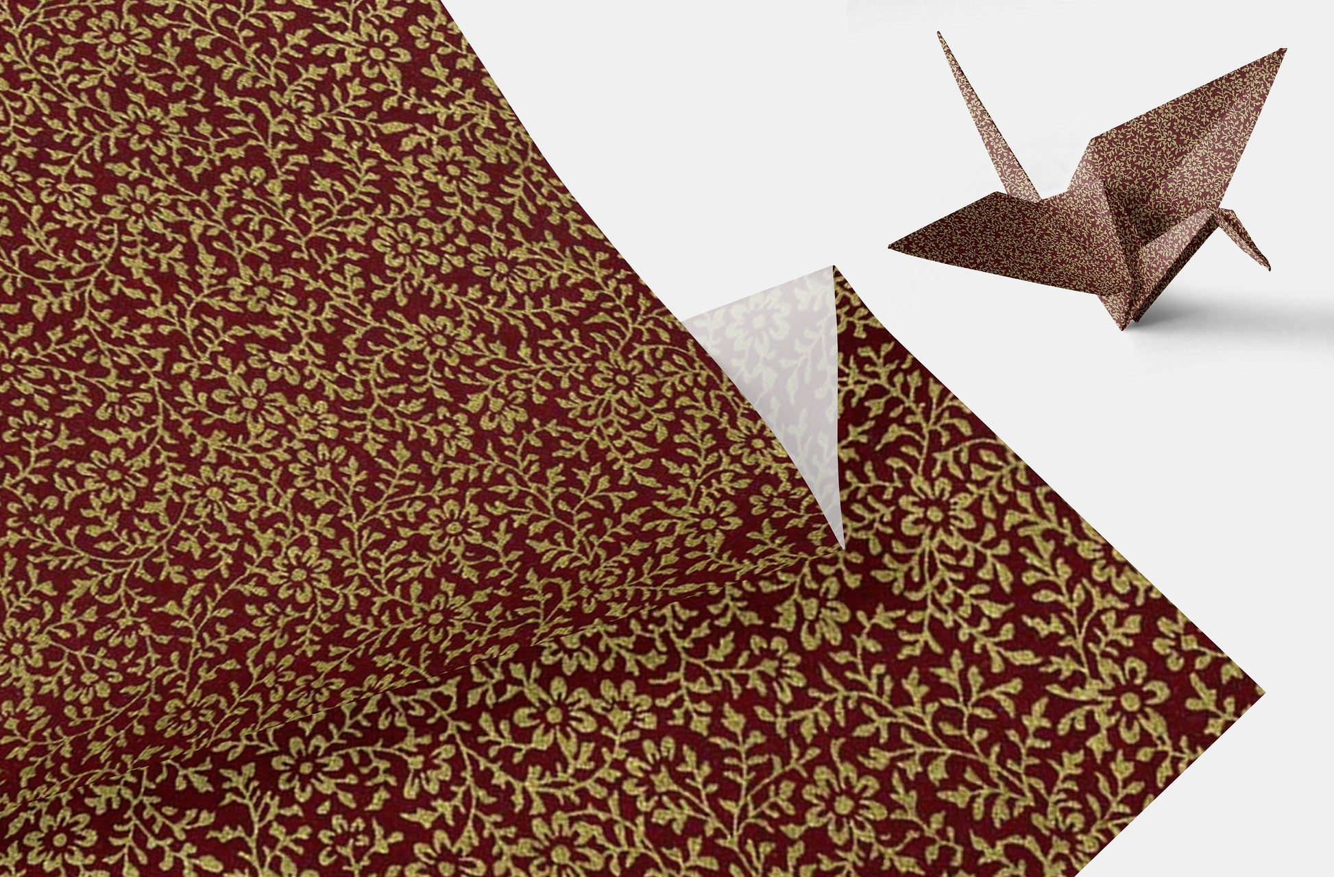 Brown floral-patterned paper with a folded corner and an origami crane on a white background