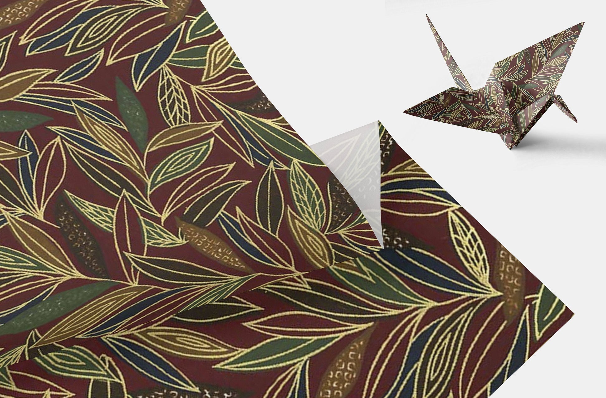 Patterned paper with leaf design and a folded paper crane on a white background