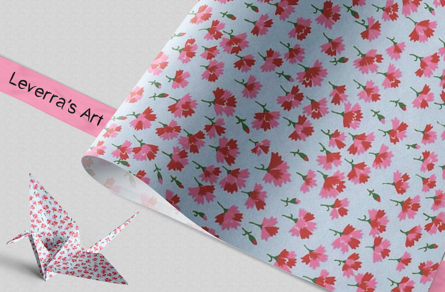 Floral patterned paper with a pink ribbon and origami crane on a light gray background